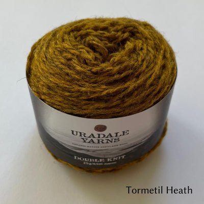 cake of Uradale DK yarn in color Tormentil Heath- heathered yellow/gold