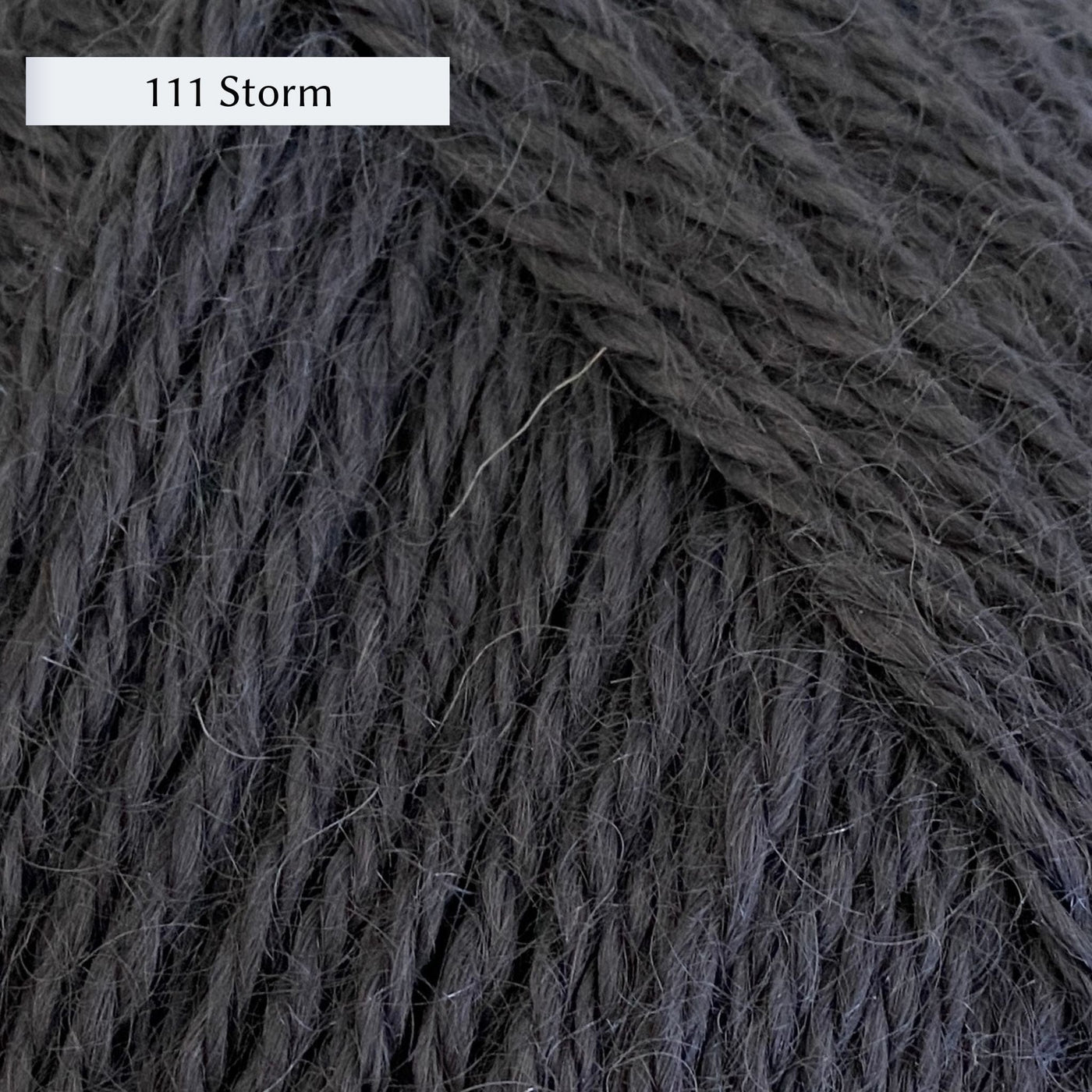 Wensleydale Longwool Aran, an aran weight yarn made from Wensleydale sheep, in color 111 Storm, a dark solid grey