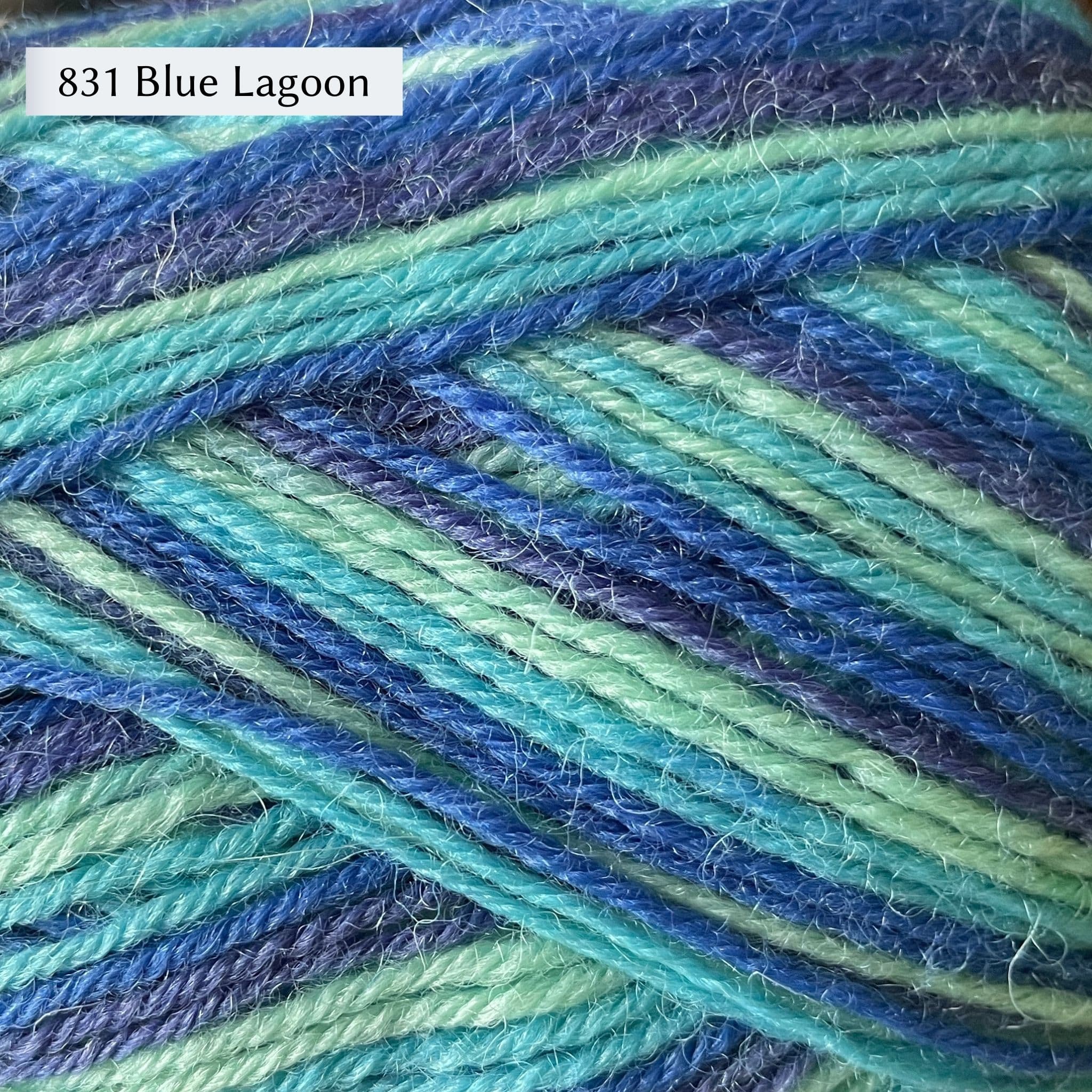 West Yorkshire Spinners Signature 4ply yarn, fingering weight, in color 831 Blue Lagoon, a striping yarn in shades of blue from dark blue to turquoise and aqua