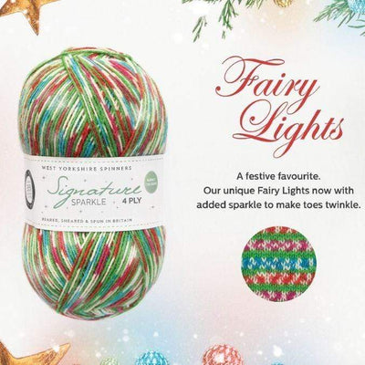 West Yorkshire Spinners Signature 4ply yarn, fingering weight, in color Fairy Lights, a self-patterning holiday yarn with green stripes, and sections of white and pink, white and blue, and white and orange