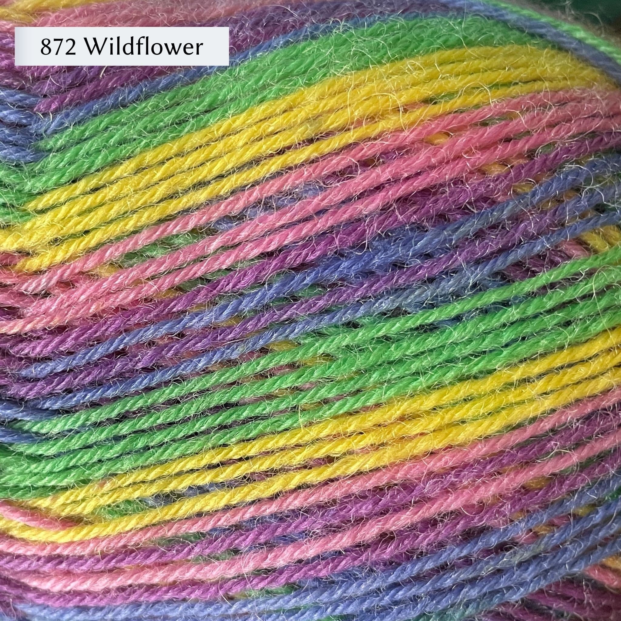 West Yorkshire Spinners Signature 4ply yarn, fingering weight, in color 872 Wildflower, a striping colorway with lime green, yellow, bubblegum pink, purple, and blue.