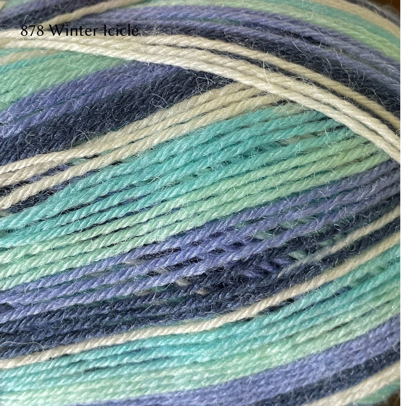 West Yorkshire Spinners Signature 4ply yarn, fingering weight, in color 878 Winter Icicle, a striping colorway in cream, aqua, seafoam, cornflower blue, and navy
