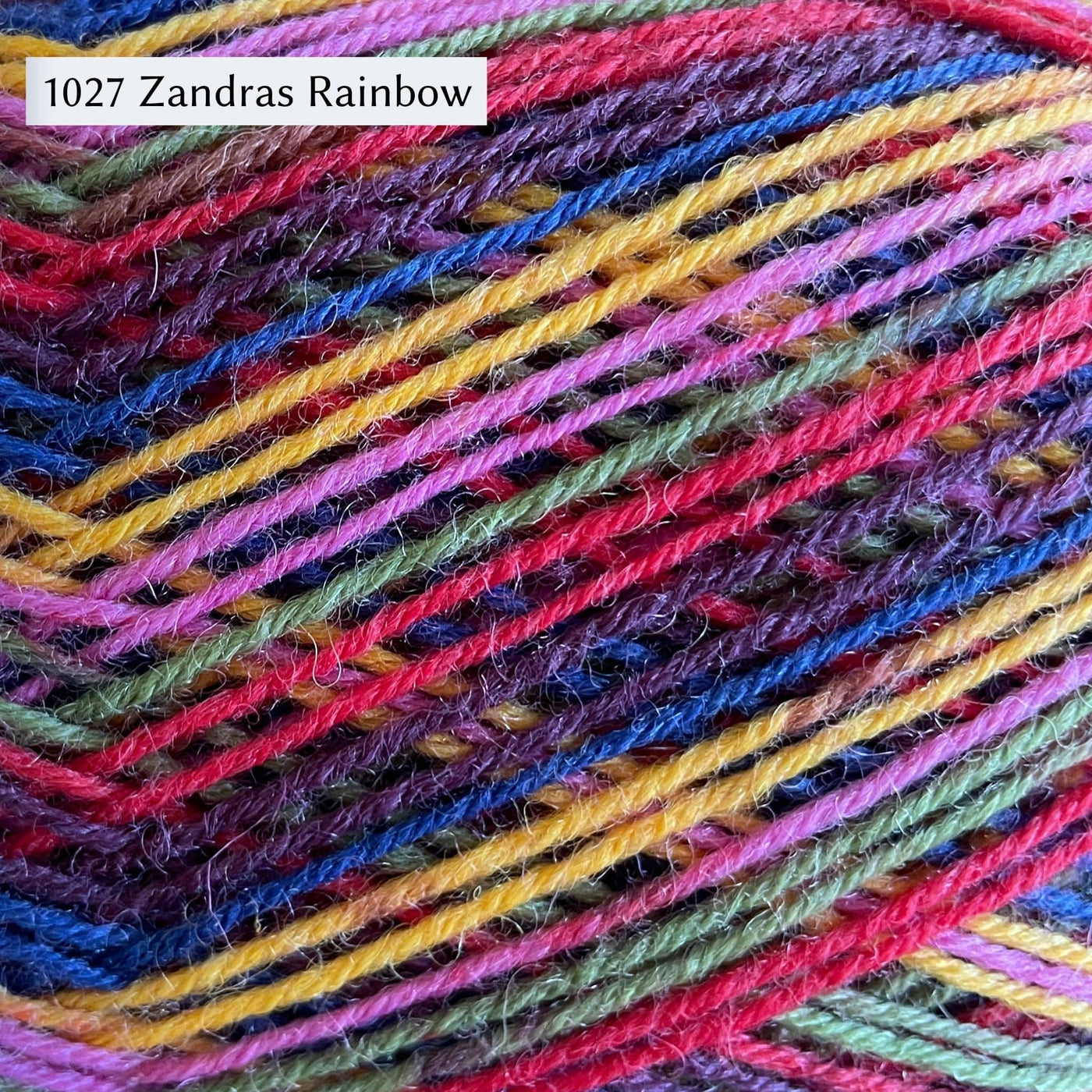 West Yorkshire Spinners Signature 4ply yarn, fingering weight, in color 1027 Zandras Rainbow, a multicolor rainbow of dark purple, royal blue, yellow, pink, light green, and red.