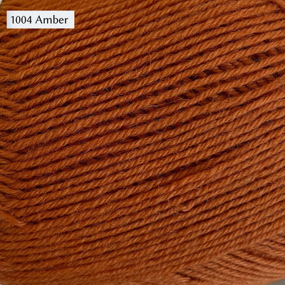 West Yorkshire Spinners Signature 4ply yarn, 100-gram ball, fingering weight, in color 1004 Amber, a warm rusty orange. 