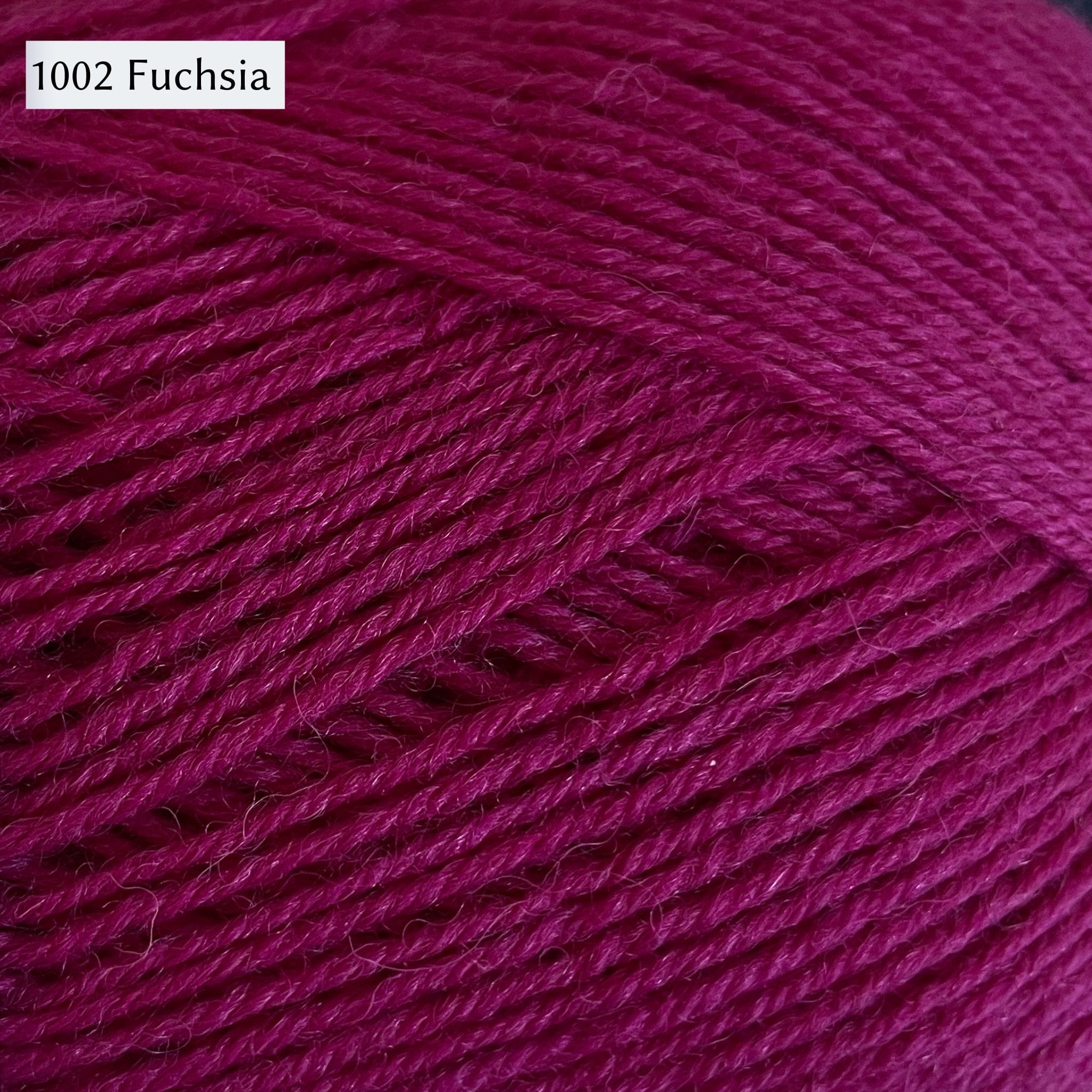 West Yorkshire Spinners Signature 4ply yarn, 100-gram ball, fingering weight, in color 1002 Fuschia, a saturated cool red color