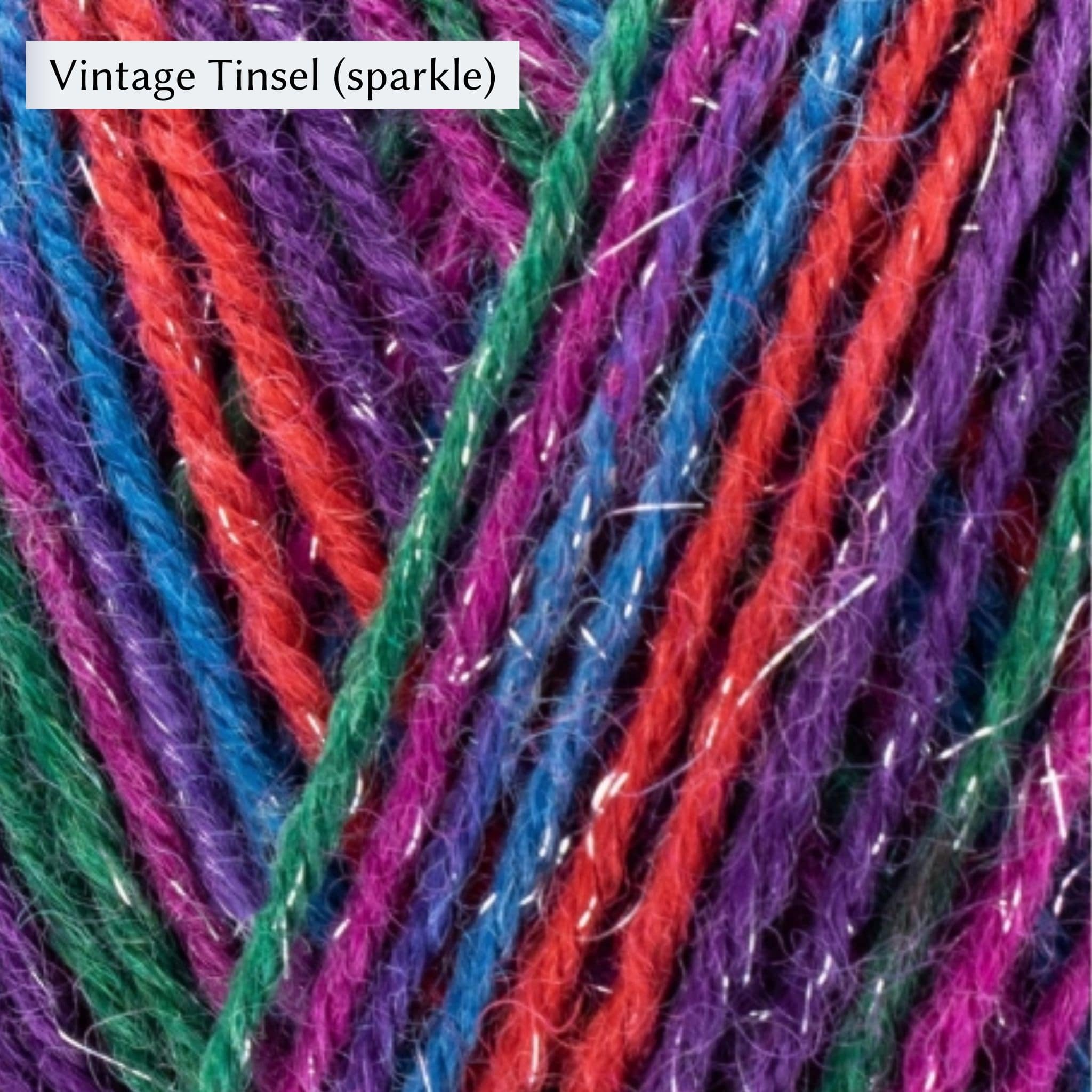 West Yorkshire Spinners Signature 4ply yarn, fingering weight, in color Vintage Tinsel (sparkle), striping in purple, red, blue, magenta, and green, with sparkle